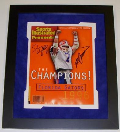 Both QB Danny Wuerffel and Coach Steve Spurrier of the NCAA Florida Gators have hand signed this Commemorative Sports Illustrated (Full Magazine-not just the cover) with Blue sharpie pens. This Commemorative Sports Illustrated came out in 1996 and was available only in Florida, for a limited time, which makes it even more special that it's signed by both champions and Heisman Trophy Winners! The Black custom wood frame measures 13x15 inches, and the double matting consists of a Blue Suede top matting over a White bottom mat. Conservation Clear glass was used on this fine piece to protect the autograph from fading due to UltraViolet Rays. This custom made frame is ready to hang on the wall! This item comes with a Real Deal Memorabilia Certif