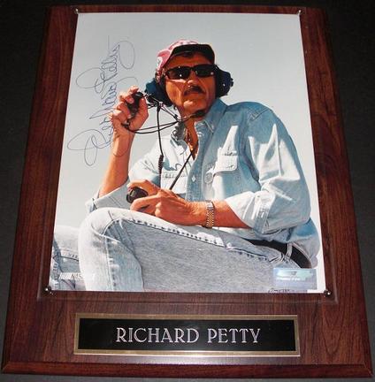 Richard Petty "Sitting" Autographed Racing 8" x 10" Photograph on a wall plaque